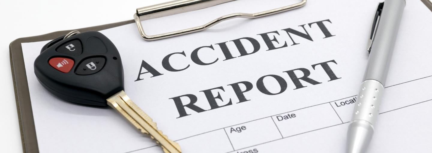 Car keys, pen, and accident report