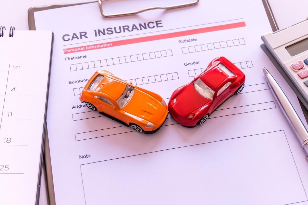 Toy cars on top of insurance form