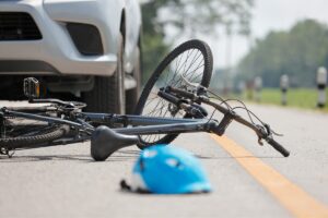 Accident between a bicycle and a car on the road