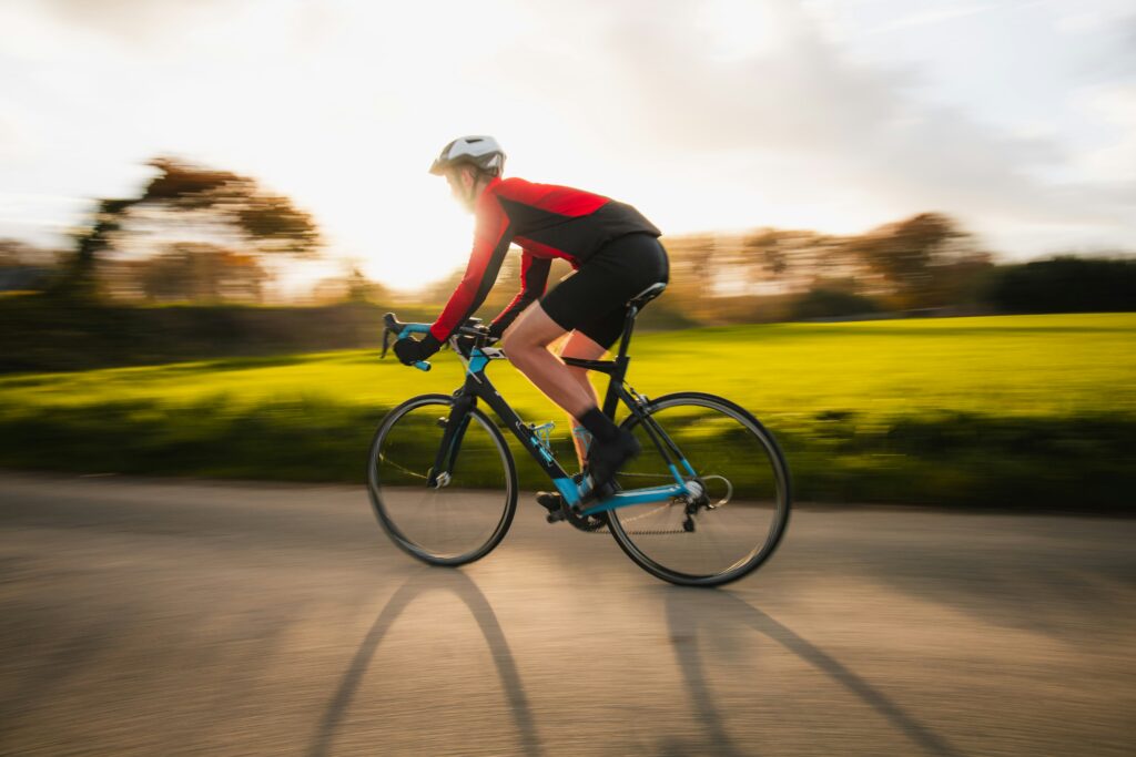 Cyclist riding on a rural Kansas road at sunset