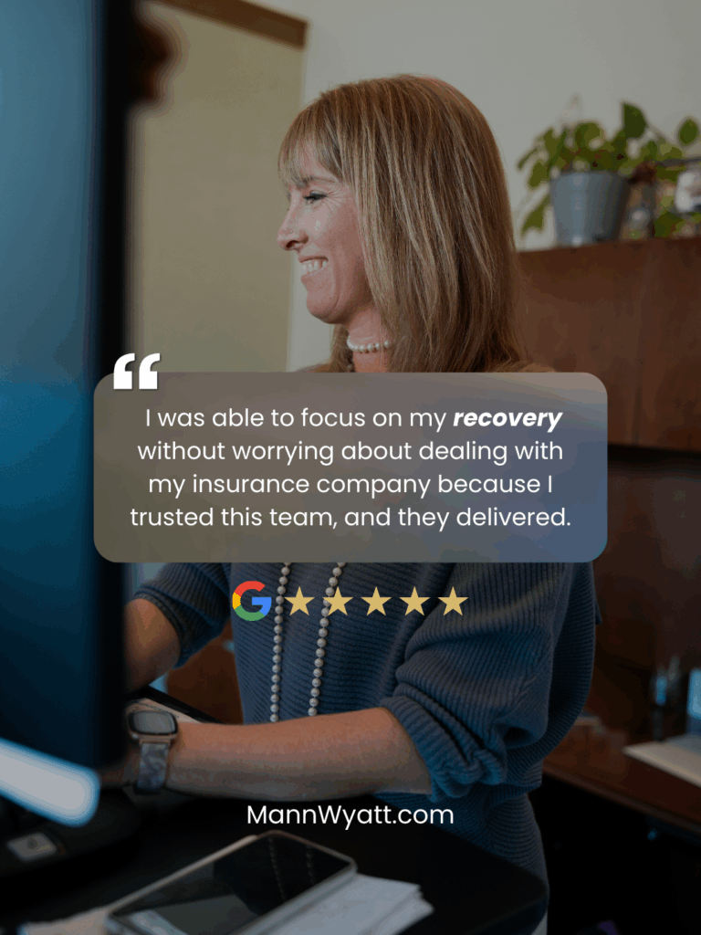 Smiling woman working at her desk representing a satisfied client of Mann Wyatt Tanksley Injury Attorneys, Kansas City pedestrian accident lawyers.