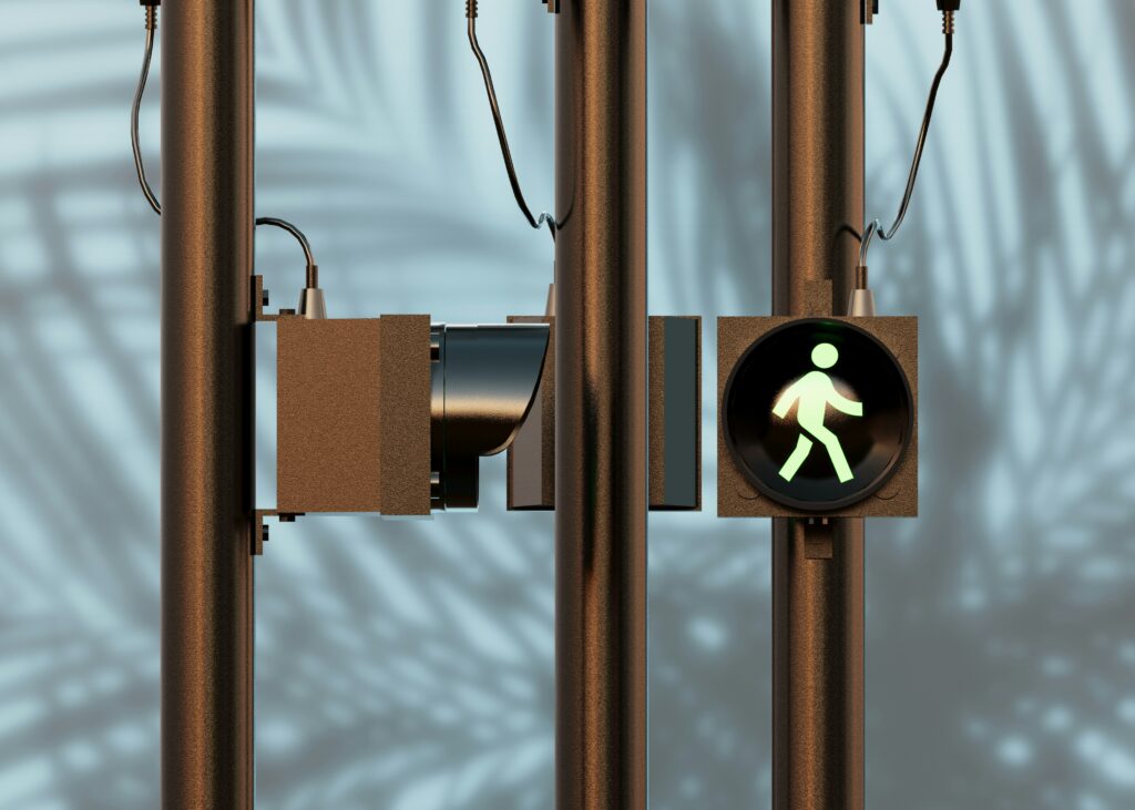 Close-up of a pedestrian crosswalk signal showing a green walking figure, symbolizing safety and pedestrian right-of-way.
