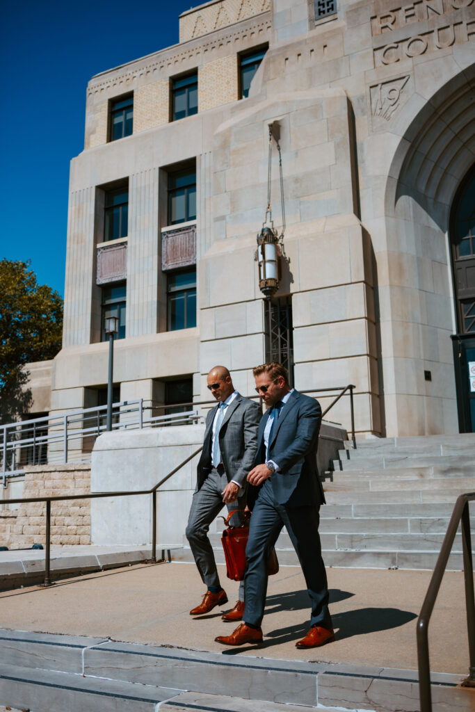 Attorneys Mike Wyatt and Jesse Tanksley in suits walk down the courthouse steps, symbolizing experienced legal representation and advocacy for injured workers.